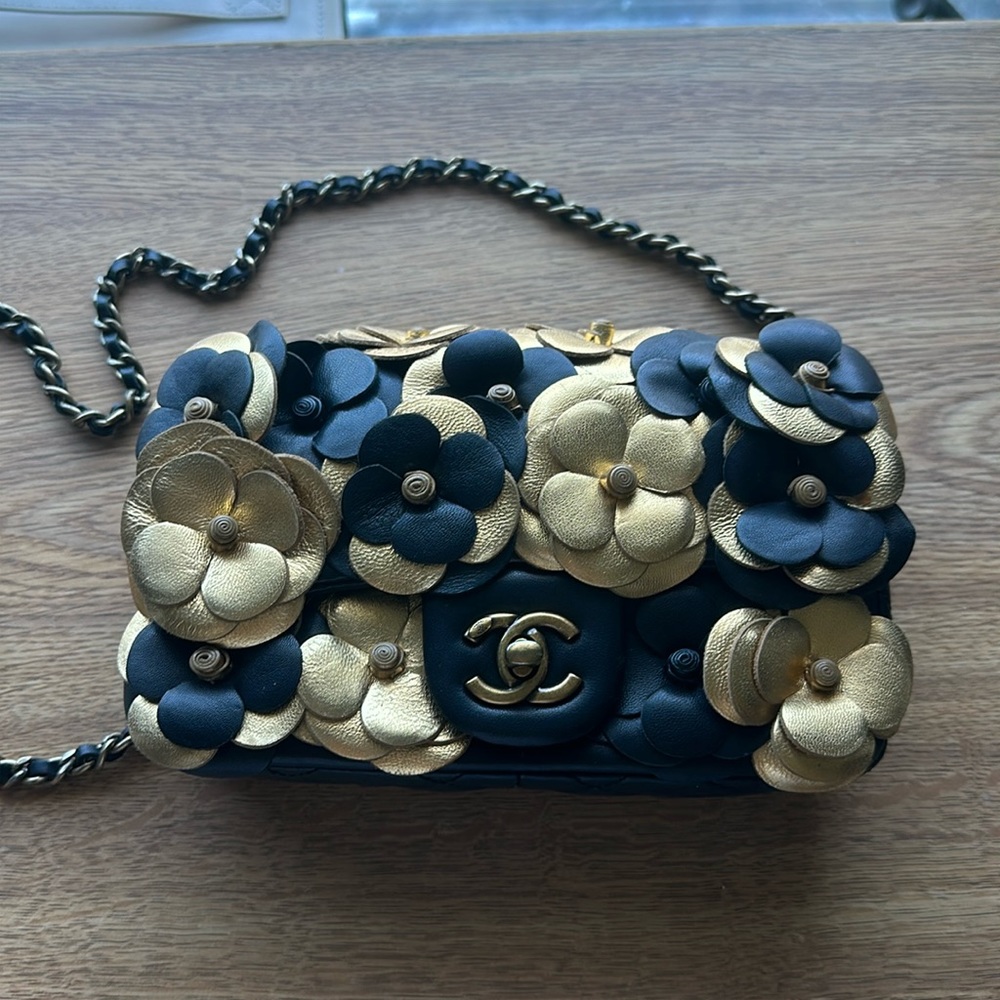 This is a lovely cocktail purse, pure leather, black and gold by Chanel